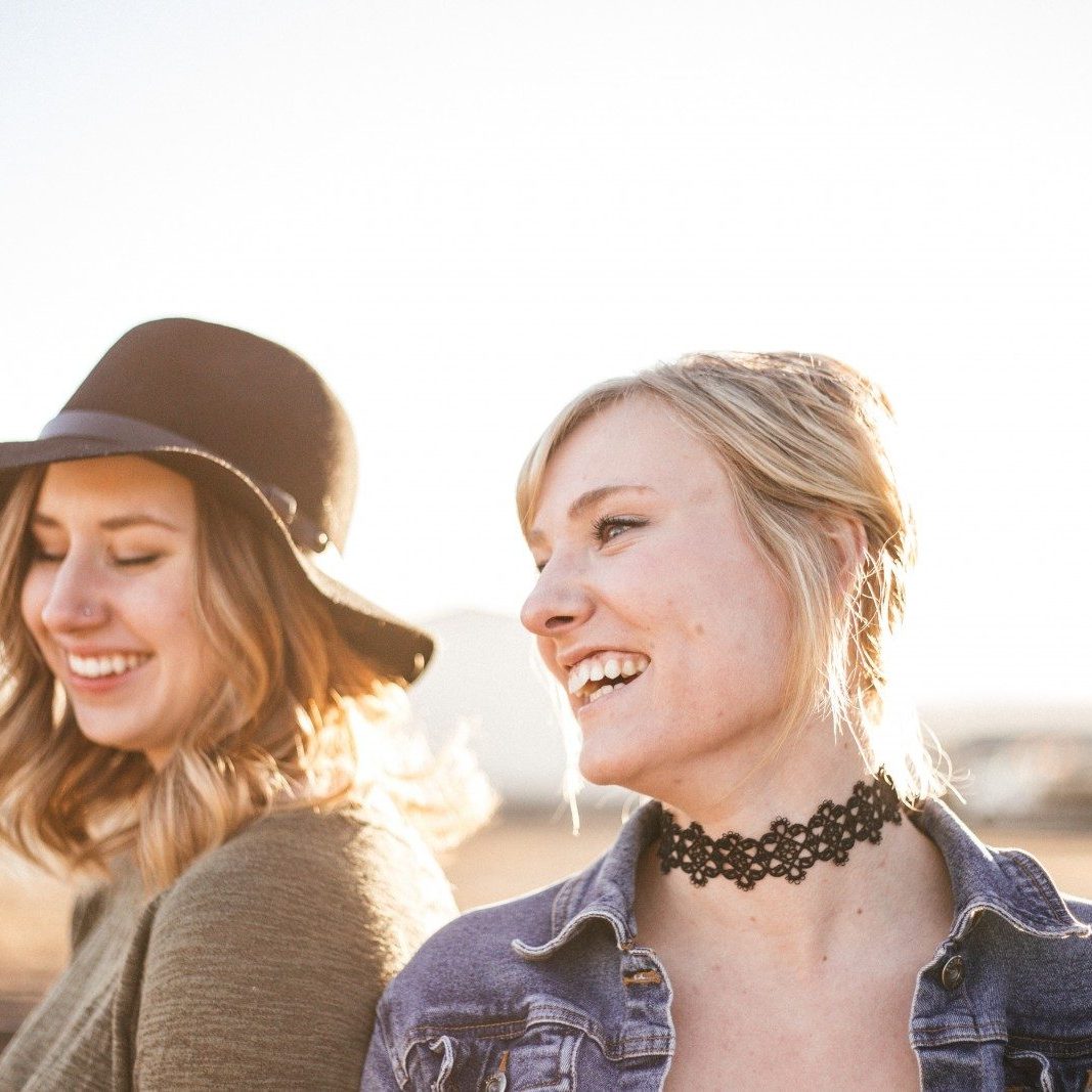 two woman taking a sideview selfie